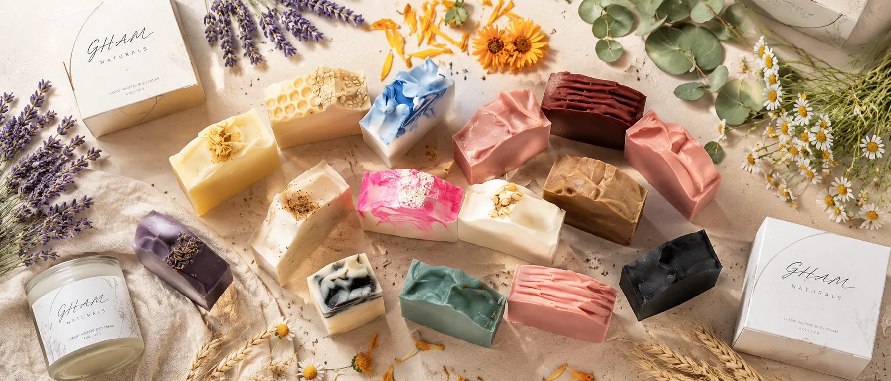 GHAM Naturals soaps, branded boxes and body cream arranged in a premium flatlay